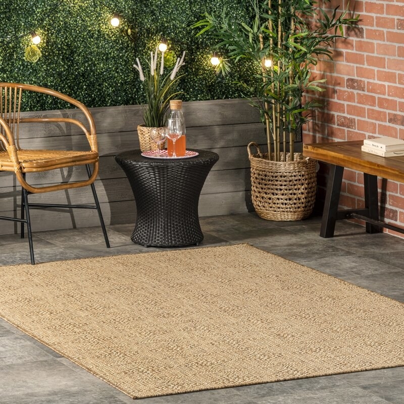 the brown geometric rug on a patio