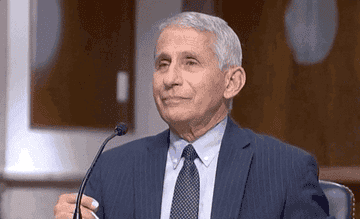 Dr. Anthony Fauci putting on a face mask