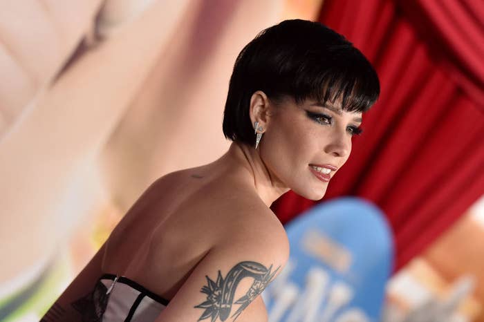 Halsey poses at a red carpet event in a strapless outfit