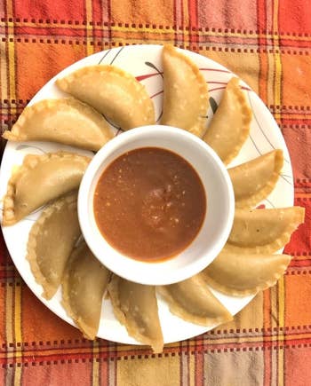 Reviewer photo of a plate of dumplings surrounding a ramekin of dipping sauce