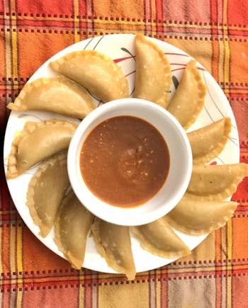 Reviewer photo of a plate of dumplings surrounding a ramekin of dipping sauce