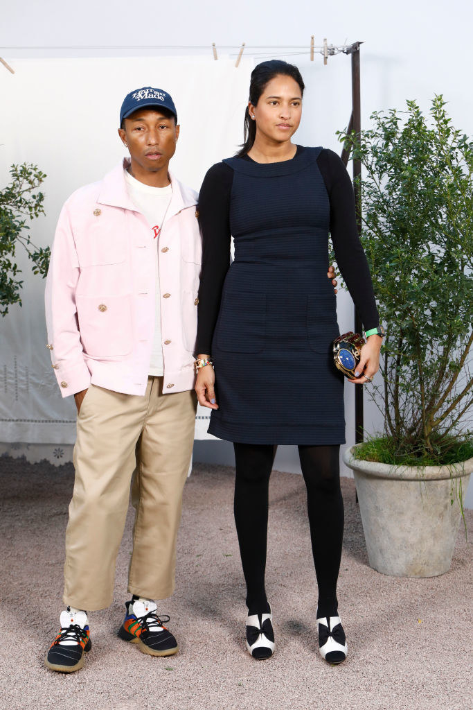 Pharrell and Helen Lasichanh posing at the Chanel fashion show