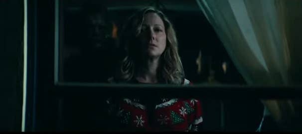 Karen standing at the window of Judith Myers&#x27;s old room with Michael standing behind her in &quot;Halloween Kills&quot;