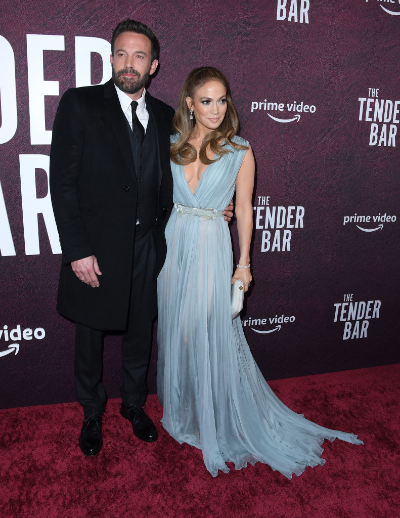 Ben Affleck and J.Lo posing on The Tender Bar step-and-repeat