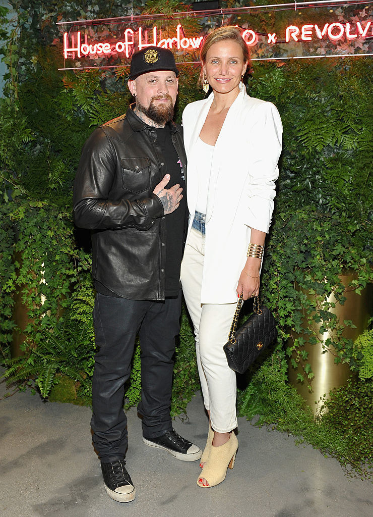 Benji Madden and Cameron Diaz posing at an event for Revolve