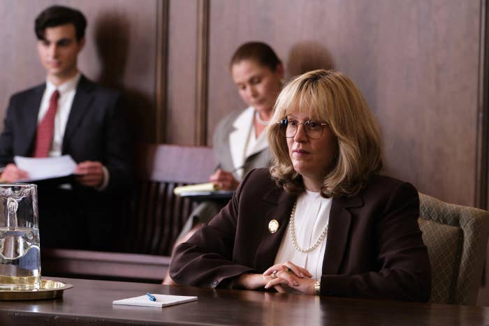 Sarah Paulson sits at a court table