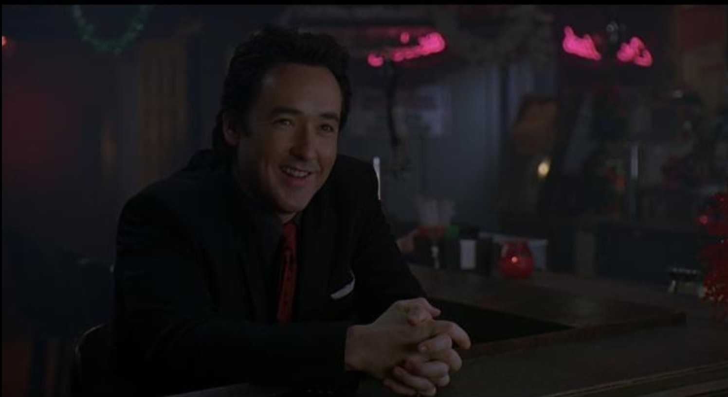 Charlie Arglist (John Cusack) converses in a strip club bar in &quot;The Ice Harvest&quot;