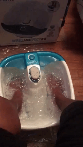 a gif of a reviewer using the foot spa's bubble feature