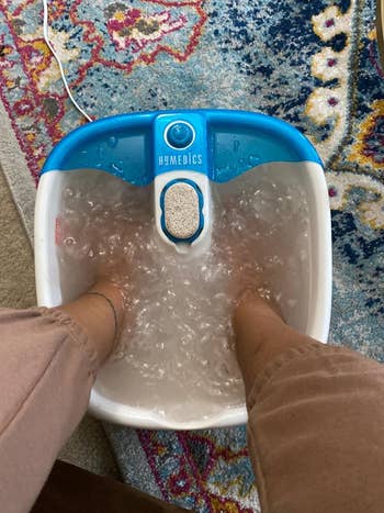 reviewer using the foot bath and showing the vibrating bubbles and the pumice stone