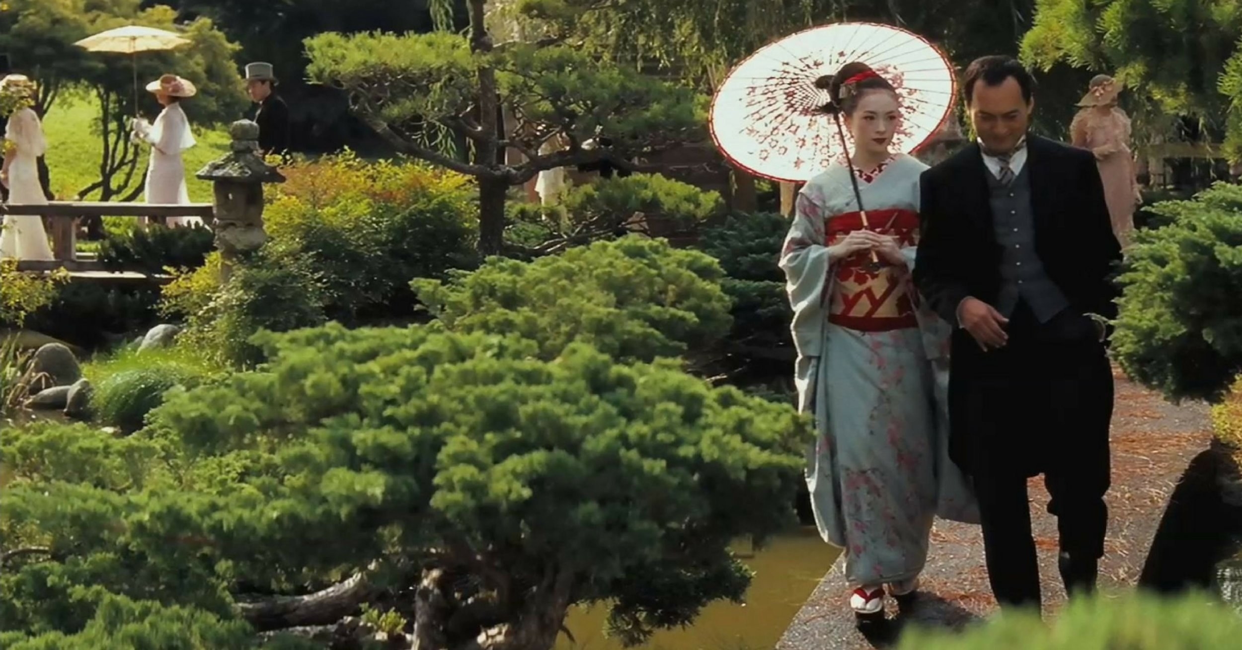 chiyo walks with the chairman in a japanese garden