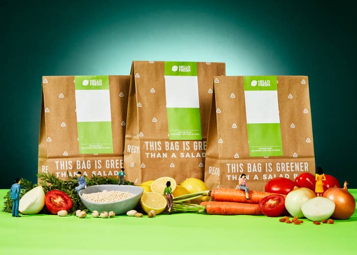 A lineup of three HelloFresh delivery bags with produce.