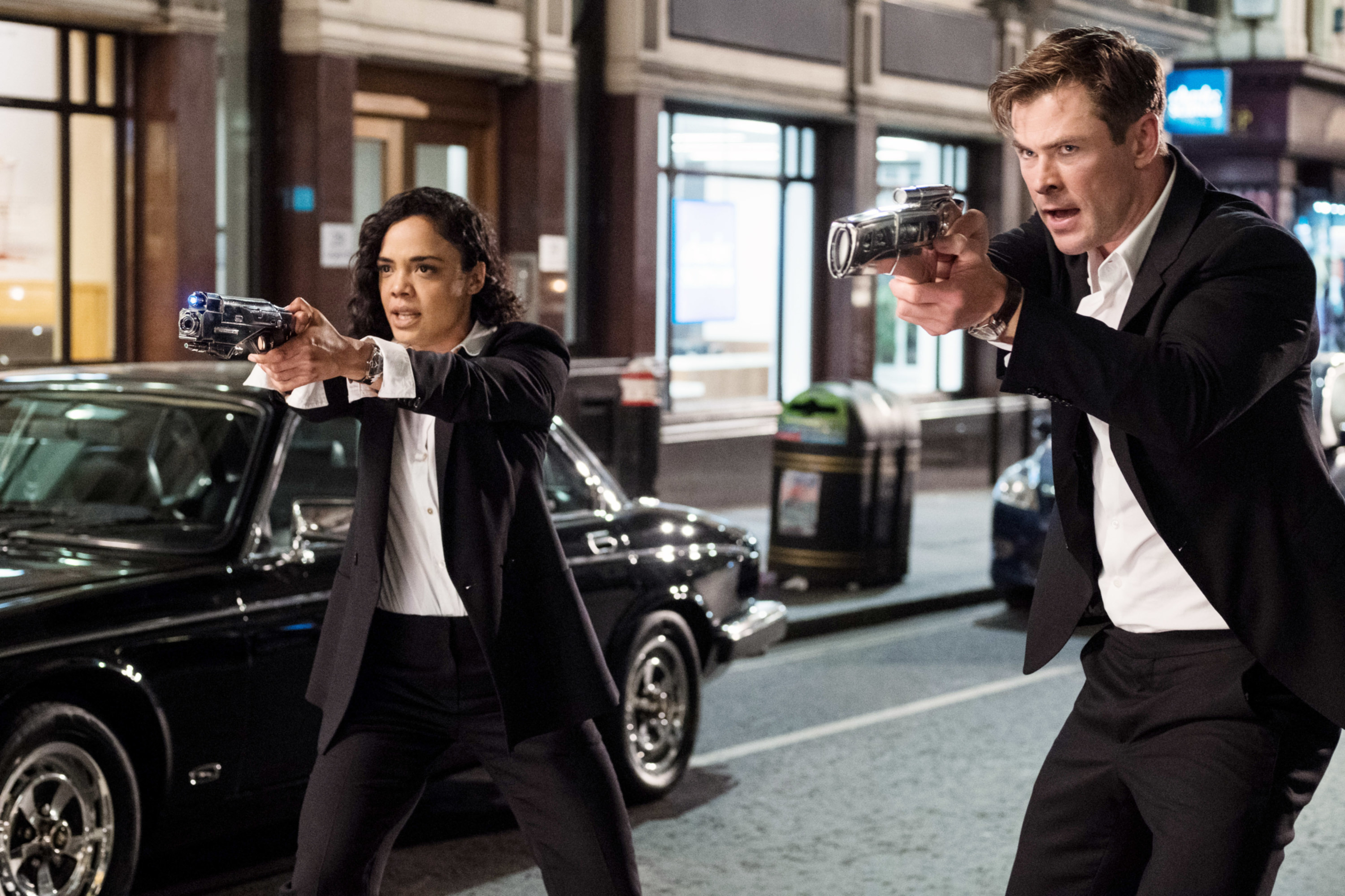 Chris Hemsworth and Tessa Thompson hold up their guns in &quot;Men in Black: International&quot;