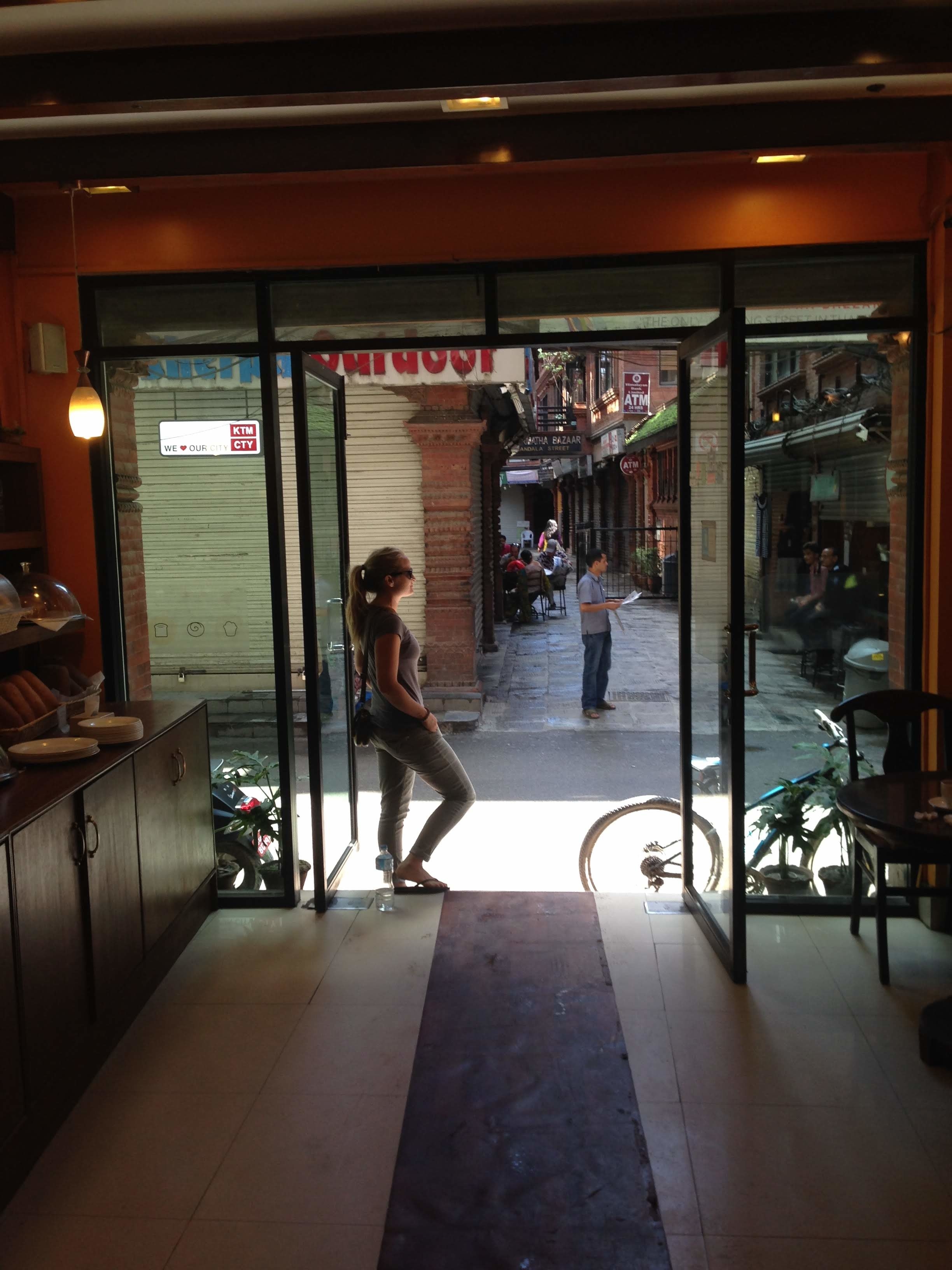 Person standing in entrance to cafe