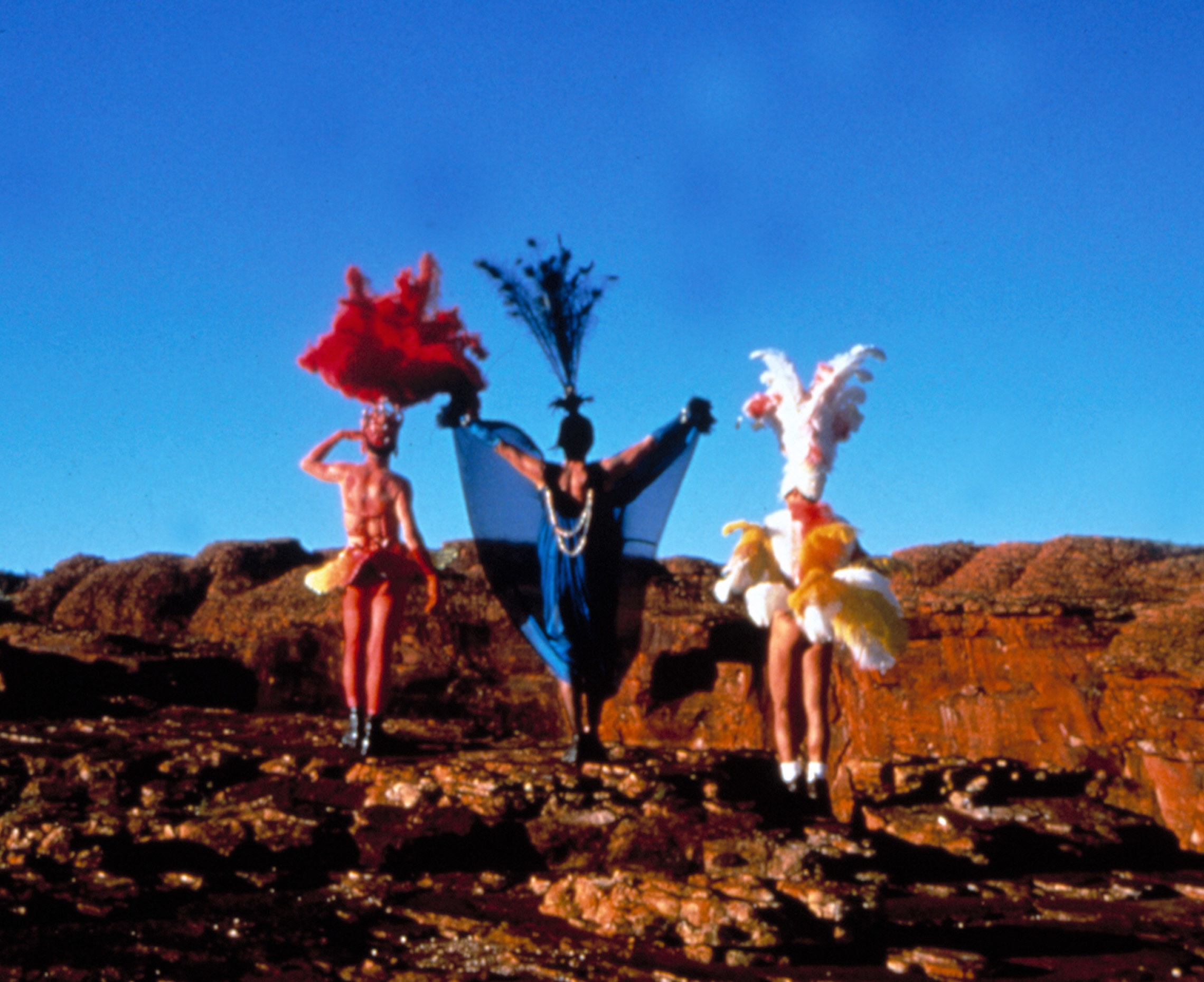 The trio of drag queens in costume in the Outback