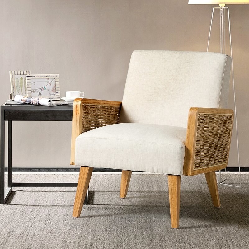 the beige chair with light rattan arms