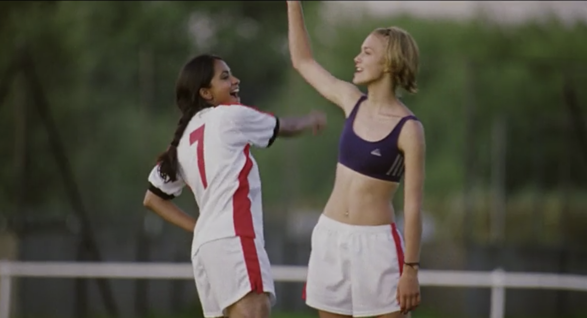 Jess wearing her 7 jersey and celebrating with another team member