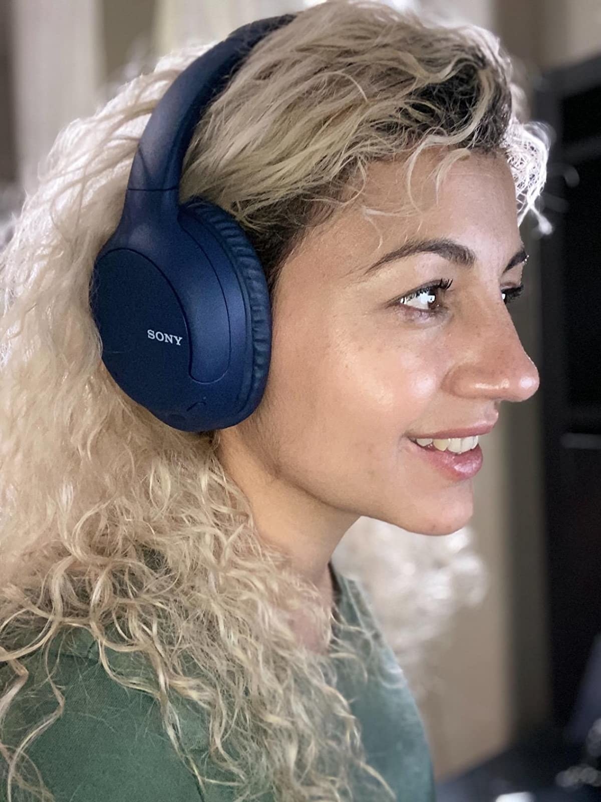 side-view of reviewer wearing the navy headphones