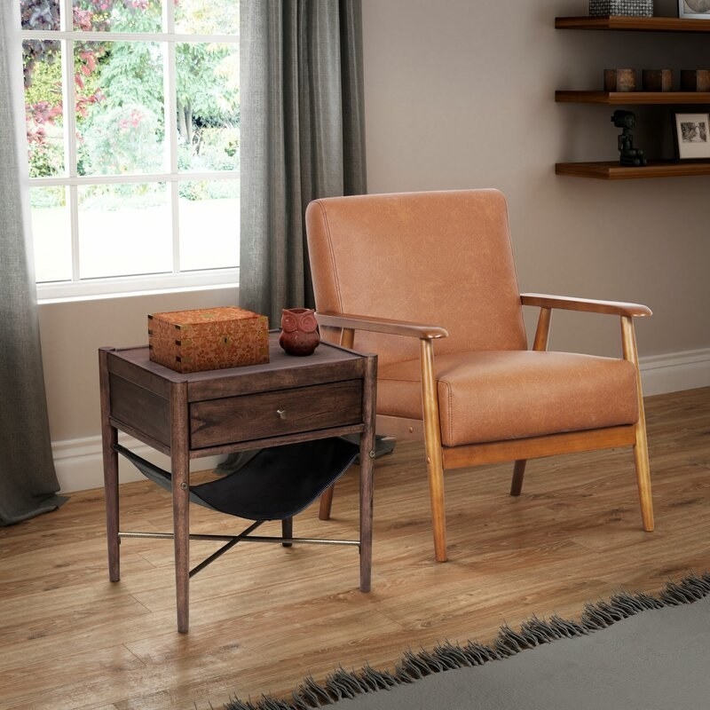 the brown leather chair next to a wooden side table