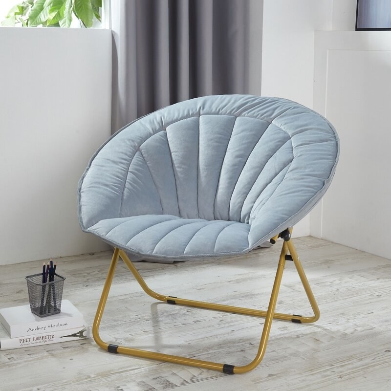 the light blue chair with gold legs