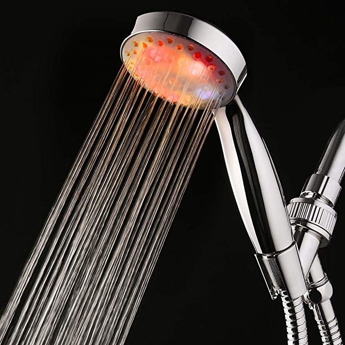 A shower head that is lit up while water runs through it