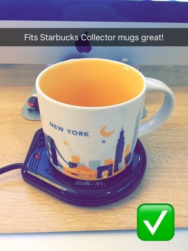 coffee mug that features the New York skyline sitting on the black mug warmer