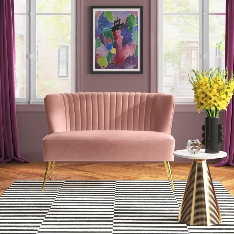 the pink loveseat in a decorated room