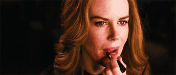 Nicole Kidman putting on lipstick
