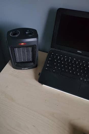 The space heater on a reviewer's desk next to a laptop