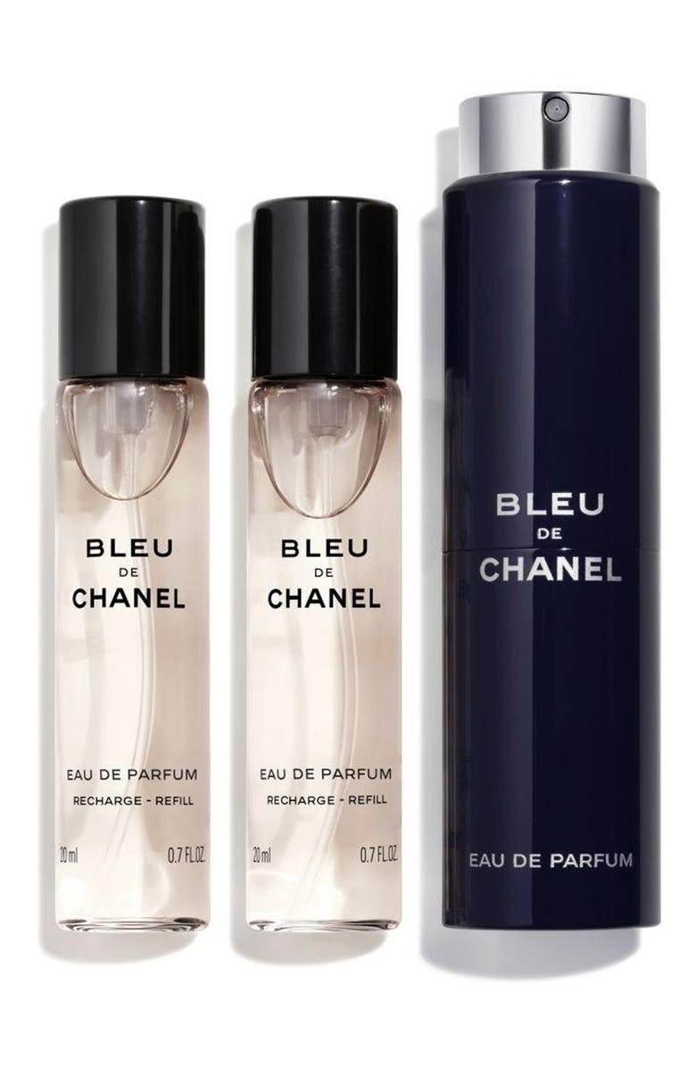 Three bottles of Chanel travel-size bottles lined up next to each other