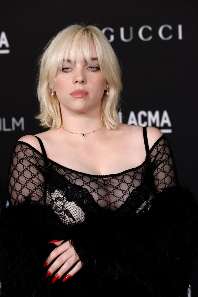 Billie at a red carpet event in a see-through Gucci top and long acrylic nails