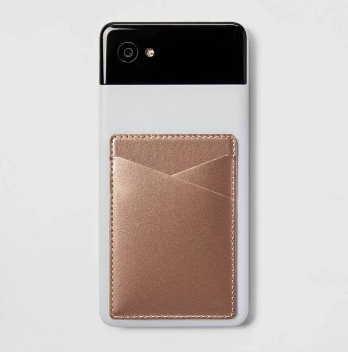 The rose gold metallic wallet pocket attached to the back of a smartphone