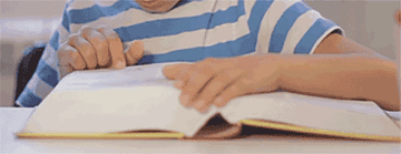 A GIF of a young person speed-reading a lengthy book