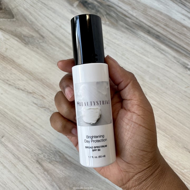 a Black hand holding the brightening day protection