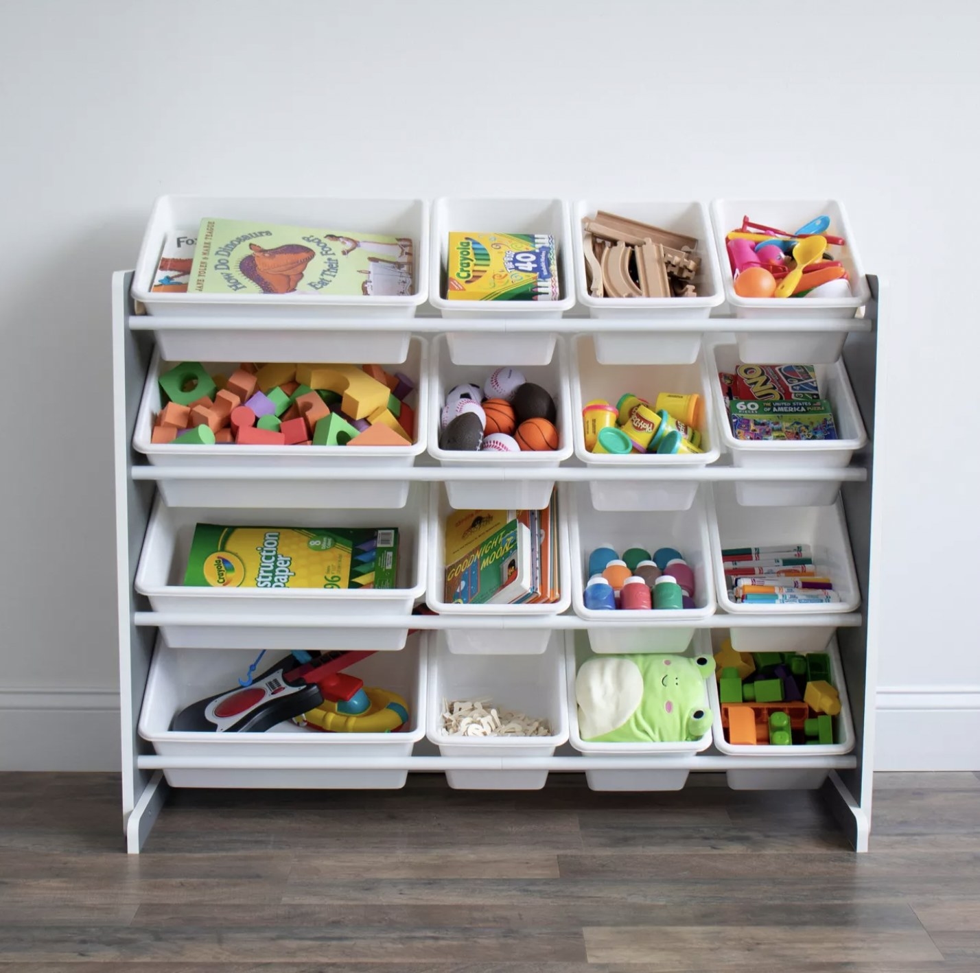 The organizing shelf with 16 white bins filled with toys