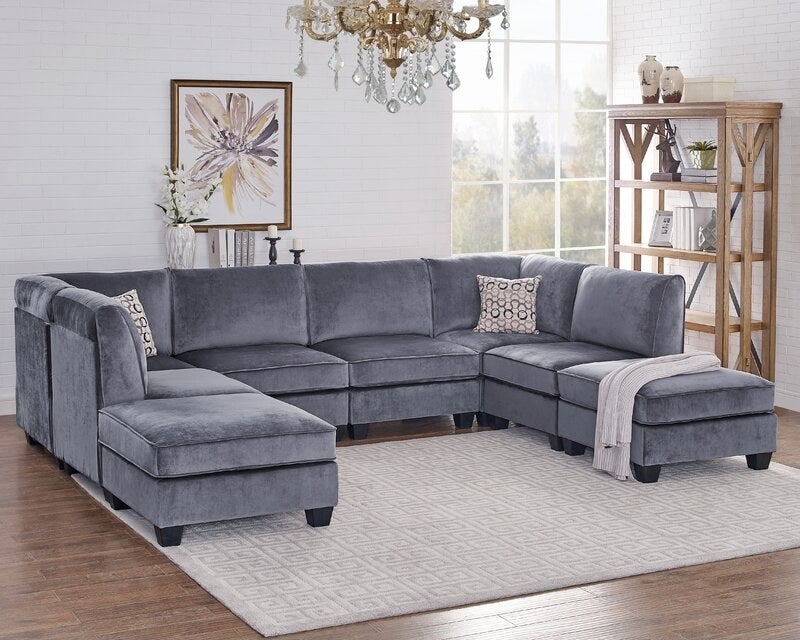 the grey velvet sofa in a decorated living room