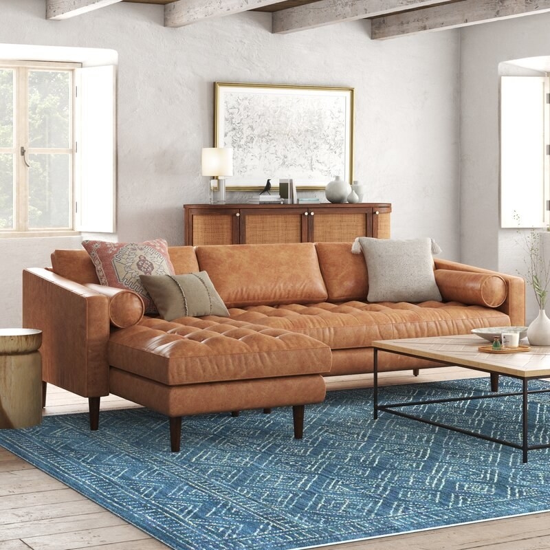 the tan leather sofa in a decorated living room