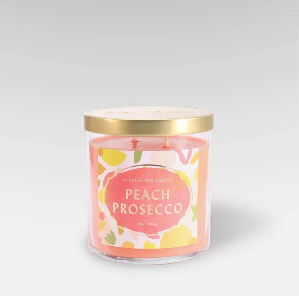 Peach colored peach prosecco candle with gold top