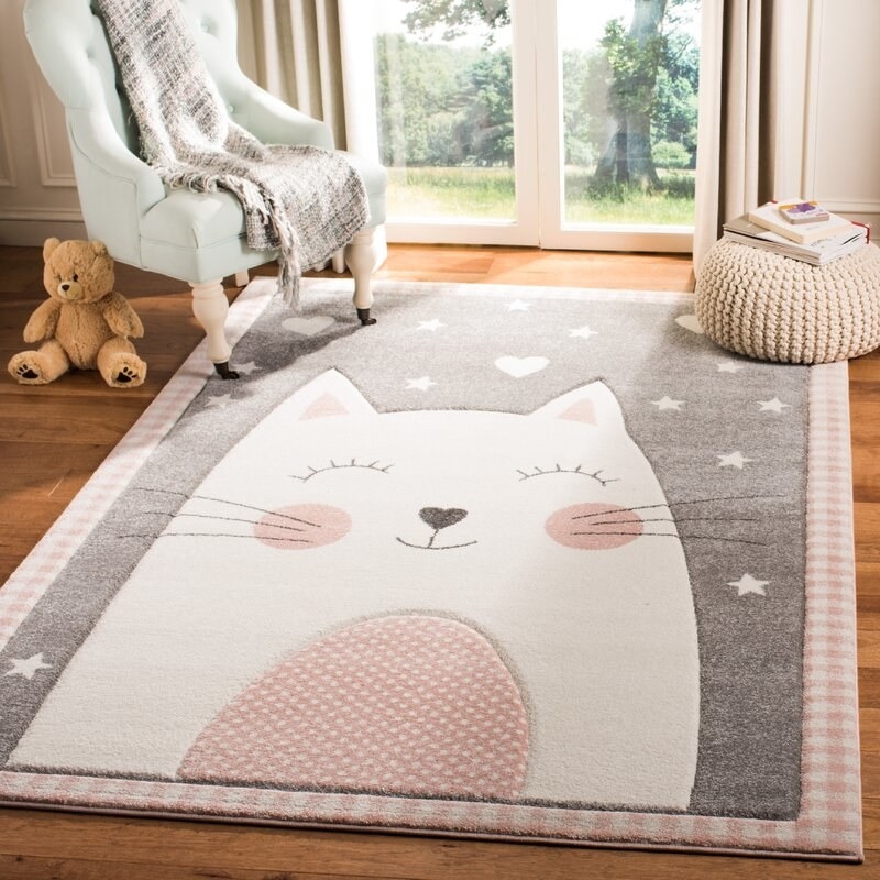 The gray area with a cat design rug in a kid&#x27;s room