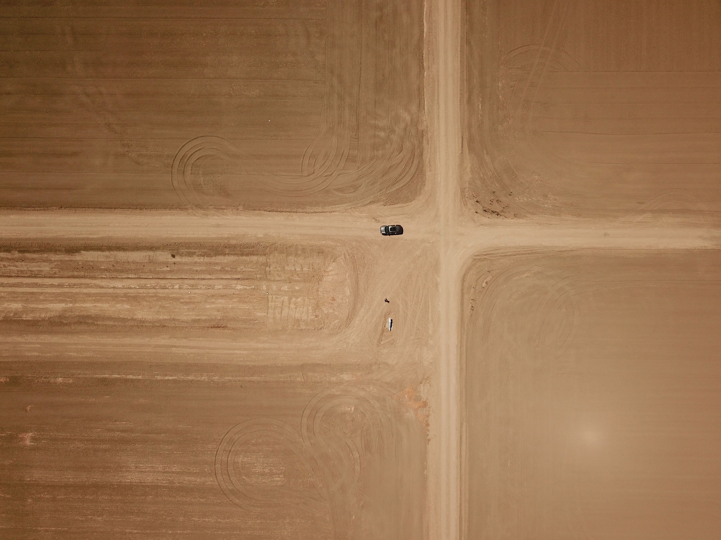 A car drives through a desolate desert area