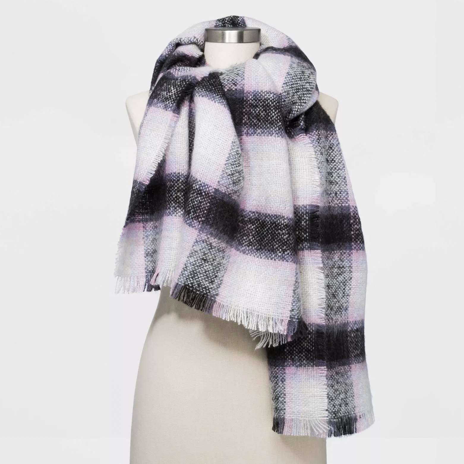 The purple, black, and white scarf with fringe detailing wrapped around a mannequin