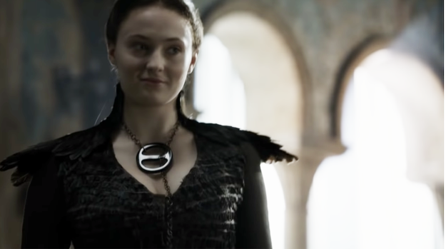 Sansa smiling slightly and wearing the necklace