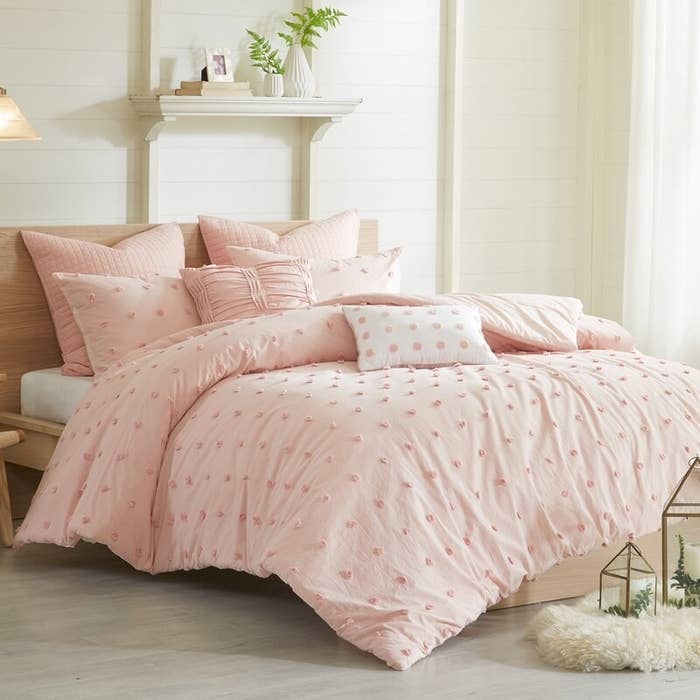 Pink comforter set shown in a bedroom