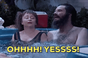 Two people sit in a hot tub