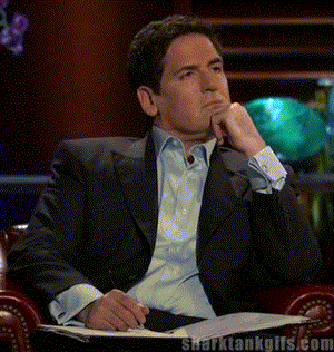 Mark Cuban writing something down in a notebook on Shark Tank