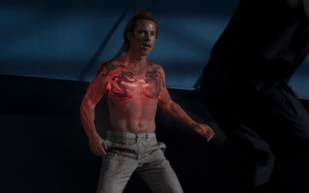 aldrich killian stands topless with his dragon tattoo as his body heats up