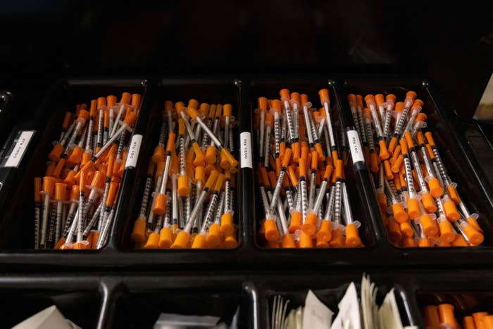 An open box displaying unused syringes