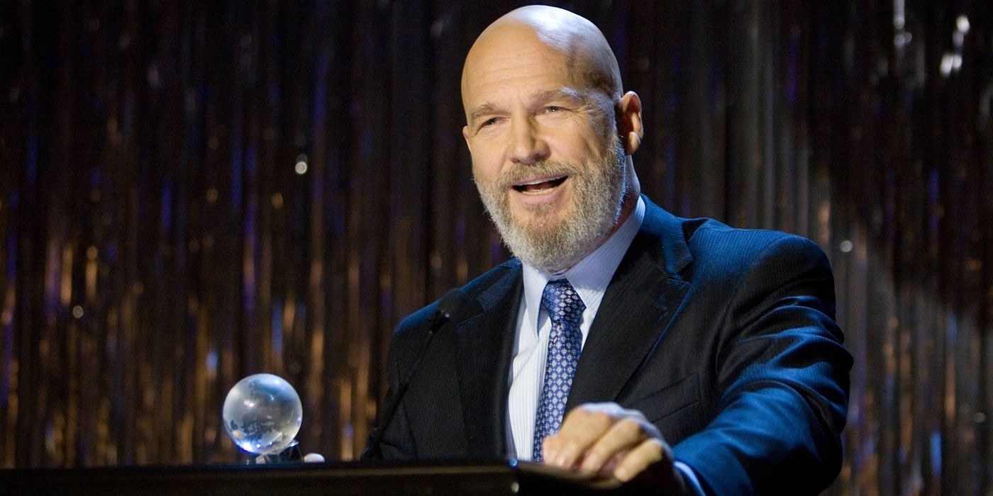 obadiah stane presents an award as he is giving a speech