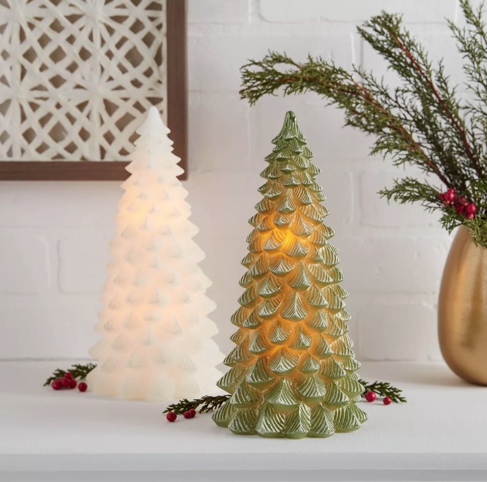 Green and white tree-shaped candles with LED light on inside