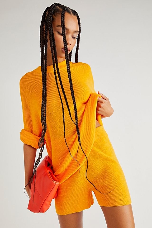 Model wearing orange set