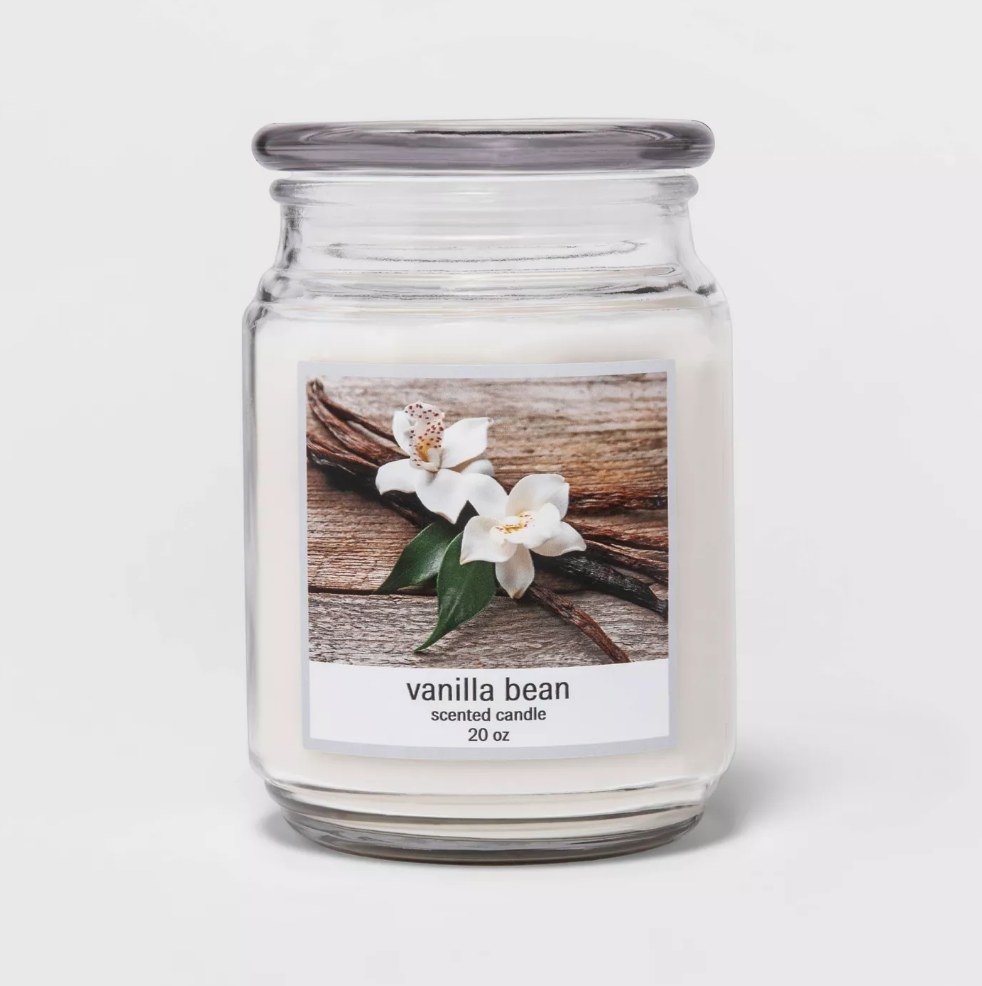 White vanilla bean candle in glass jar with glass lid